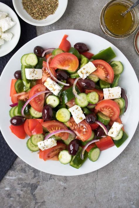 Made with fresh vegetables, salty feta cheese, and a Greek dressing, this Greek village salad (Horiatiki) is the perfect summer salad! Village Salad Greek, Greek Village Salad, Horiatiki Salad, Kay Nutrition, Village Salad, Souvlaki Recipe, Traditional Greek Salad, Greek Village, Greek Dressing