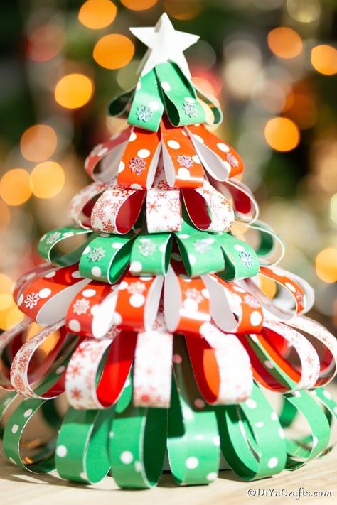 Paper Strip Mini Christmas Tree Decoration is a perfect way to a simple holiday tree idea to your decor this year. Make this paper Christmas tree and display proudly on your mantle or as a centerpiece! #diytree #christmastree #papertree #paperchristmastree #holidaydecorations #christmasdecorations Mini Christmas Tree Decorations, Homemade Christmas Tree, Christmas Tree Decorating Themes, Diy Christmas Tree Ornaments, Christmas Tree Decorations Diy, Miniature Christmas Trees, Paper Christmas Tree, Black Christmas Trees, Christmas Tree Crafts