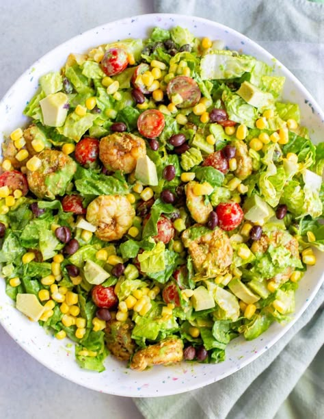 Southwestern Shrimp Salad is a chopped romaine salad with corn, black beans, tomatoes, avocado, grilled chili lime shrimp, and a homemade cilantro dressing. Shrimp Corn Black Bean Salad, Southwestern Shrimp Salad, Homesteading Meals, Southwestern Salad Recipes, Turkey Enchilada Casserole, Grilled Shrimp Salad, Corn Bean Salsa, Chili Lime Shrimp, Cilantro Dressing