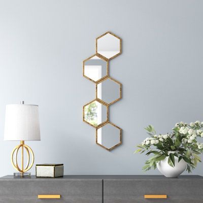 Create plenty of visual movement and rhythm in your home with this modern accent mirror display. It showcases an array of repeating hexagonal frames in your choice of finish, and they each hold a glass mirror that reflects the light and makes any room appear larger. This piece is made with an iron that can easily be mounted vertically or horizontally to your living room or bedroom wall. We love that it's safe to hang up in damp locations like your bathroom. Plus, it comes with hanging hardware f Honeycomb Mirror Wall Decor, Hexagon Mirror Wall Decor, Honeycomb Mirror, Hexagon Decor, Hexagon Mirror, Hall Mirrors, Hallway Mirror, Modern Wall Shelf, Mirror Display