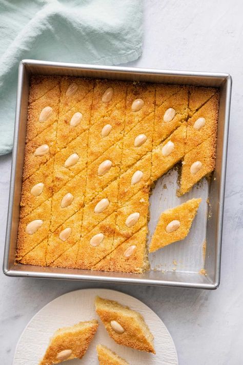 Whether you call it Namoura, Basbousa, or just Semolina cake this recipe will delight. Made with semolina flour, almonds, and topped with a simple syrup. | Lebanese Recipe | Middle Eastern Cake | Semolina Cake | Namoura | Basbousa | Ramadan Dessert| Ramadan Recipe | Namoura Recipe, Lebanese Desserts Recipes, Basbousa Recipe, Semolina Cake Recipe, Semolina Recipe, Ramadan Sweets, Ramadan Recipe, Custard Cake Recipes, Lebanese Desserts