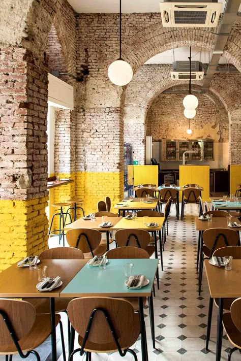 The exposed-brick arches at Berberè Navigli pizzeria in Milan are dipped in buttery-yellow paint. Dim Sum Restaurant, Pizzeria Design, Bar In Casa, Kursi Bar, Yellow Interior, Modern Restaurant, Bar Interior, Coffee Shop Design, Cafe Interior Design