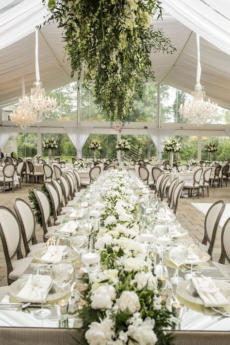 A King's tablescape as the head table with a mirrored top, a long floral runner with white blooms and verdure, with a long mossy fixture suspended overhead. Long Table Wedding, Louis Chairs, Garden Wedding Reception, Cincinnati Wedding, Garden Reception, Wedding Reception Flowers, Elegant Wedding Reception, Romantic Garden Wedding, Wedding Reception Centerpieces