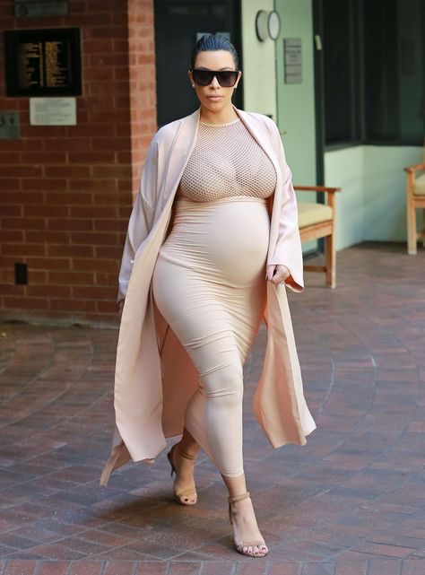 Kim stuck to her signature neutrals in a high-waisted body-con skirt that she met with a racy mesh top. She added a duster coat and completed her look with taupe ankle-strap sandals. Kim Kardashian Pregnant, Estilo Kim Kardashian, Estilo Kardashian, Kardashian Photos, Kim Kardashian Style, Pregnancy Looks, Nude Dress, Kardashian Style, Pregnancy Outfits