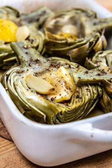 Cooking An Artichoke Made Easy: Baking Artichokes - This Mess is Ours Whole Artichoke Recipes Baked, Housewife Duties, Baked Artichokes, Cooking Artichokes, Easy Paella, How To Cook Artichoke, Baked Artichoke, Roasted Artichoke, Hearty Snacks