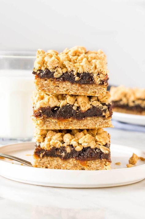 Old-fashioned date squares have a delicious oatmeal crumble and chewy date middle. Also known as matrimonial bars - this recipe has the perfect ratio of crumble to filling, with a hint of cinnamon for a delicious flavor. #datesquares #matrimonialbars #matrimonial #dates #crumble #oldfashioned #dainties from Just So Tasty Oatmeal Fudge, Date Recipes Desserts, Butter Tart Squares, Oatmeal Fudge Bars, Oatmeal Crumble, Delicious Oatmeal, Retro Desserts, Date Squares, Date Bars