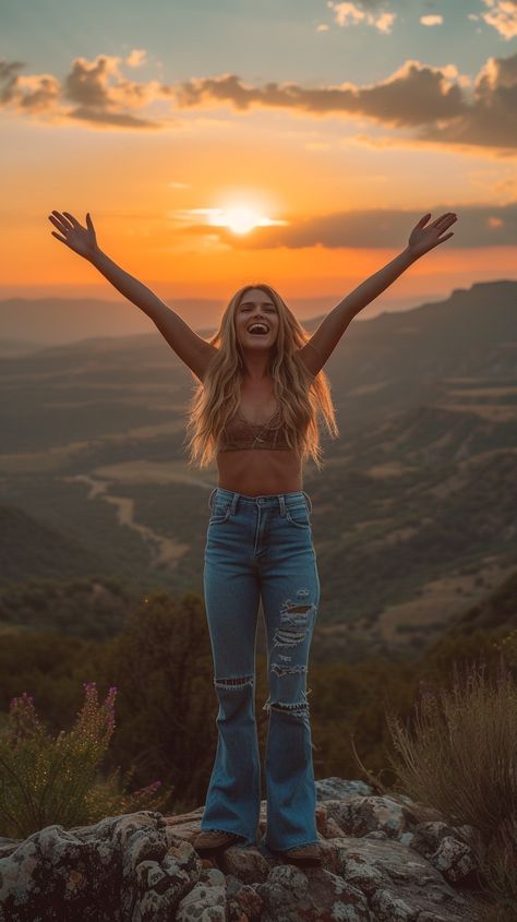 In the waning light of a breathtaking sunset, a young woman stands atop a mountain, her arms raised high in a gesture of freedom and joy. The golden hues of the sun reflect a sense of peace and fulfillment as she seems to immerse herself in the beauty of the natural world. Her silhouette against the vibrant sky creates a powerful image of human connection to the earth and the endless horizon ahead. Free Spirit Photoshoot Ideas, Freedom Nature, Relaxed Woman, Female Confidence, Free Spirit Photoshoot, Wild Women Photoshoot, Woman With Arms Outstretched, Free Woman, Empowered Women Photography