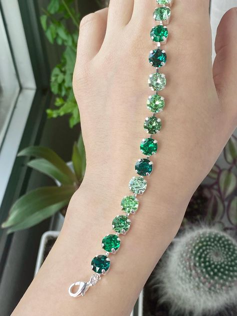 ♥ Absolutely gorgeous and beautifully handcrafted crystal bracelet made with the finest Austrian crystals that will elevate your expectations for quality and brilliance.  This bracelet includes premium quality Emerald and Peridot Austrian crystals combined in different shades.  ♥ Perfect as jewelry for weddings, parties, weekends out with your friends, and even for everyday wearing. ♥ This bracelet also makes the perfect gift, we can ship directly to your loved one and include a note. Gemstone: Premium Austrian Crystals  Shape and cut: Round Brilliant  Metal: High quality Silver plate over brass. Nickel and lead free. Measurements: 17cm + 5cm chain extender  ♥ Matching necklace: https://www.etsy.com/listing/1816723674/ombre-emerald-necklace-silver-rose-gold?click_key=f95188435d0a527babda10