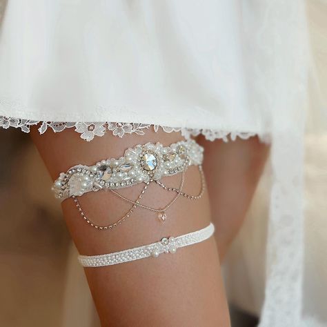 A special accent for your Wedding look with a luxury aesthetic vibe is already found! This sparkling premium garter for bride is sewn manually from high quality materials, embellished with rhinestones, crystals, and seed beads, with a whimsical dangle, and will definitely add a special touch to your outfit. All our thigh garters for wedding are handmade, sewn according to your measurements, and comfortable for long wearing during the ceremony. You can choose the luxury wide bridal garter or set with a lovely slim toss garter to make your Wedding look even fancier - choose the option in the drop-down window. 🤍Width in the central part of the keepsake garter - 1.2"/3cm, elastic's width - 0.8in / 2cm, weight - 0.055 lb (25 g) 🤍Width of the elastic toss garter - 0.8" / 1.8cm, weight - 0.011 Garter For Wedding, Thigh Garters, Garters For Wedding, Leg Garter, Wedding Garter Set, Bridal Garter, Wedding Garter, Garter Set, Light Ivory