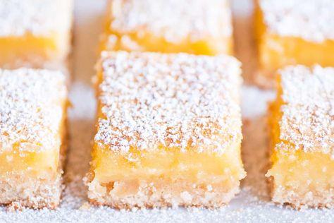 Ina Garten is widely known for her simple yet delicious recipes (and the show, Barefoot Contessa). Full of down-to-earth charm and attitude, Ina's Lemon Bars are a great example of Ina's trademark style; you will never find overdressed food at an Ina Garten party. The dessert is as much fun to make as it will be to eat Ina Garten Lemon Bars, Best Lemon Bars, Lemon Bars Easy, Lemon Bars Recipe, Lemon Squares, Ina Garten Recipes, Lemon Flavor, Smitten Kitchen, Lemon Bars