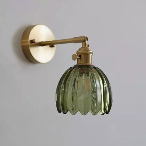 Nestled between the realms of elegance and nostalgia, the Tulip Wall Sconce effortlessly captivates with its timeless allure. Crafted with a delicate tulip lampshade, meticulously fashioned from translucent glass in six enchanting hues, this gold wall sconces emanates a whimsical glow that gracefully dances across any space. The copper base and lamp body exude a rustic charm, evoking a sense of vintage grandeur. Its adjustable lamp head allows for personalized illumination, while the stunning li Kitchen Table Ideas, Gold Wall Sconces, Hallway Sconces, Lemon Press, Luminaire Vintage, House Updates, Candle Wall, Vintage Light Fixtures, Creative Kitchen