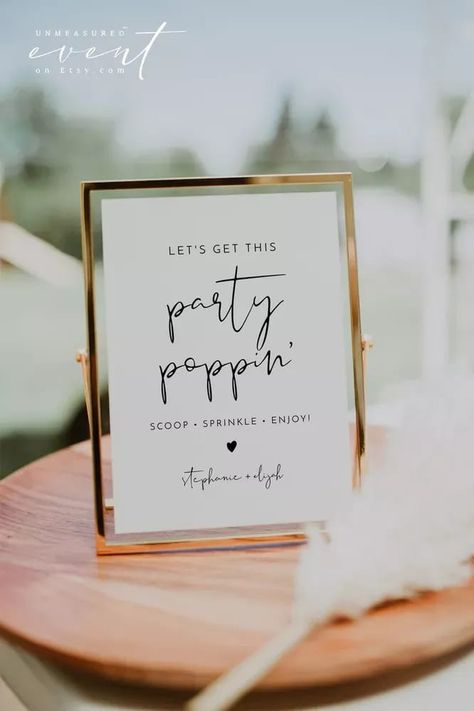 ADELLA Collection popcorn sign that reads "let's get this party popping" in an elegant script font that has a modern minimalist design. sign is in a gold frame and is sitting on a wooden table. All via Unmeasured Events Popcorn Bar At Wedding, Popcorn Bar Wedding Cocktail Hour, Popcorn Machine Wedding, Popcorn Bar For Wedding, Popcorn Wedding Bar, Popcorn Station Wedding, Modern Snack Bar, Popcorn Bar Wedding, Popcorn Bar Party