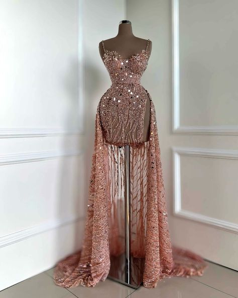 To order DM us @reineecouture . The gown showcased is a breathtaking floor-length creation in a delicate blush pink hue. Its fitted bodice is meticulously adorned with intricate beading and shimmering sequin embellishments, adding a refined sparkle that enhances its elegance. The sweetheart neckline, paired with slim, possibly adjustable straps, offers a graceful yet supportive look. A cinched waist transitions into a flowing skirt featuring vertical sheer panels or cutouts, introducing a uni... Rose Gold Evening Gown, Rose Gold Gown, Structured Gown, Gold Sequin Gown, Nude Gown, Rose Gold Dress, Intricate Beading, Gold Gown, Rose Gold Beads