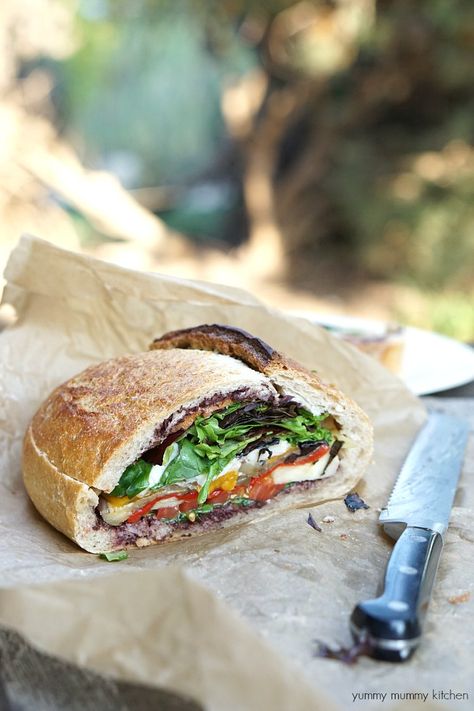 This vegetarian and vegan stuffed muffaletta sandwich is perfect for picnics. Vegetarian Stuffed Peppers, Picnic Sandwiches, Vegan Sandwiches, Cold Sandwiches, Olive Tapenade, Vegetarian Sandwich, Vegan Sandwich, Tapenade, Roasted Peppers