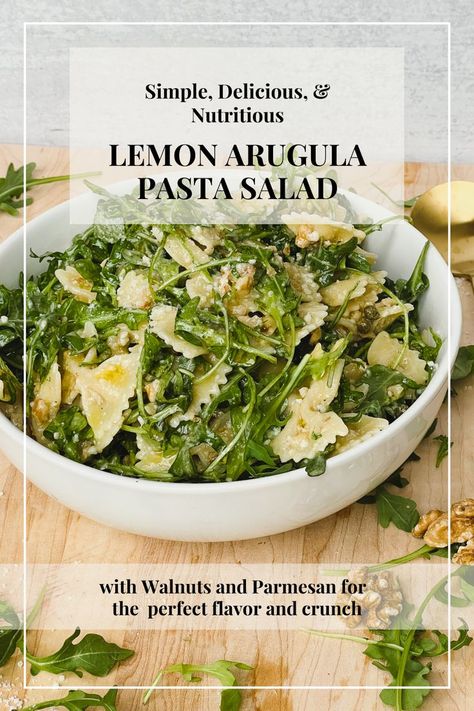 background image shows white bowl containing lemon and arugula pasta salad with bowtie shaped pasta. It sits on a light brown cutting board. Text overlay reads "Simple, delicious, and nutritious Lemon Arugula Pasta Salad with Walnuts and Parmesan for the perfect flavor and crunch." Lemon Arugula Pasta, Arugula Pasta Salad, Arugula Pasta, Arugula, Delicious Salads, Soup And Salad, Gnocchi, I Love Food, Healthy Lunch