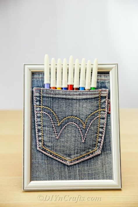 Make this great pen organizer from an old pair of jeans and a picture frame. This easy DIY pen pocket will help to clear the clutter from your desk and keep pens organized. Diy Mermaid Tail, Diy Pen, Cardboard Car, Pen Organizer, Clear The Clutter, Jeans Pocket, Pom Pom Rug, Pencil Organizer, Etsy Diy