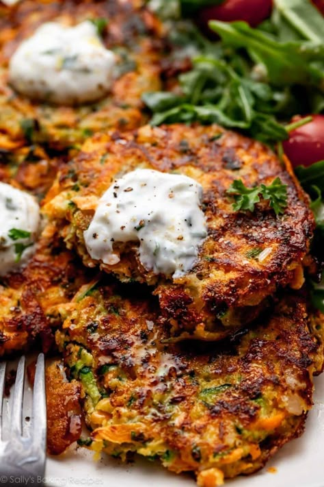 Golden brown and crisp, these delicious zucchini sweet potato fritters are naturally gluten free and taste incredible with cool and creamy yogurt sauce. Flavored with onion, garlic, and fresh herbs, these savory little cakes cook quickly on the stove and are welcome at breakfast, lunch, and dinner. Recipe on sallysbakingaddiction.com Recipes With Zucchini, Roasted Vegetable Lasagna, Sweet Potato Fritters, Potato Fritters, Vegetable Lasagna, Sally's Baking, Roasted Vegetable, Zucchini Fritters, Fritter Recipes