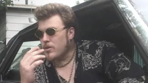 man with sun glasses sitting in a beat up old car. he’s wearing a long sleeved button up shirt with a black and white design on it. Trailer Park Boys Ricky, Ricky Tpb, Mike Smith, Trailer Park Boys, Funny Shows, Things Under A Microscope, Character Study, Sunglasses Fashion, Trailer Park