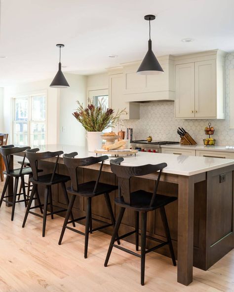 This peaceful modern farmhouse features Dura Supreme’s off-white “Putty” paint. Inspired by nature, this soft, natural paint finish creates a warm, comfortable, and relaxing mood to the home. The designer used the “Putty” paint for the majority of the kitchen cabinets, the integral canopy wood hood, and the main floor bathroom vanity on the Hudson door style. The kitchen island uses a dark “Praline” stained finish to add a nice contrast to the painted kitchen cabinetry. Putty Kitchen, Dura Supreme Cabinets, Contrasting Kitchen Island, Walnut Kitchen Island, Wood Hood, Painted Kitchen Island, Dark Wood Kitchen Cabinets, Taupe Kitchen, Kitchen Cabinet Inspiration