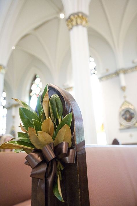 a magnolia leaves arrangement with a brown ribbon bow for the aisle decor Southern Wedding Decorations, Ceremony Space Decor, Fresh Wedding Bouquets, Simple Church Wedding, Pew Markers, Creative Wedding Centerpieces, Pew Flowers, Greenery Wedding Bouquet, Magnolia Leaf