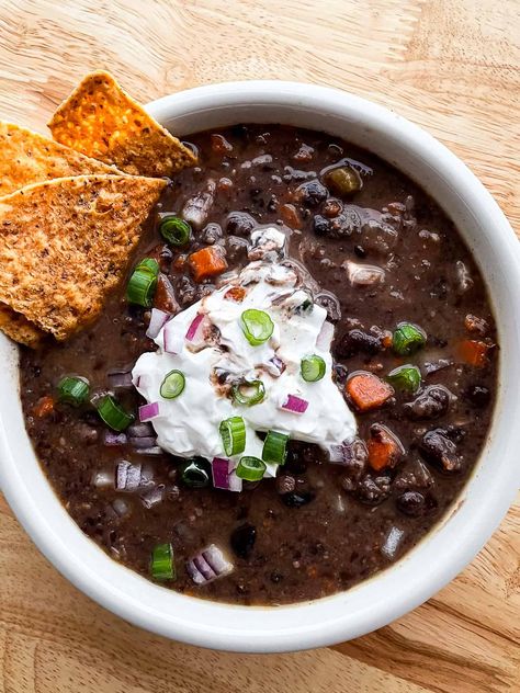 This simple black bean soup recipe uses canned black beans–making for a quick prep since you don’t need to soak the beans. The soup is flavorful and you can adjust the heat-level to suit your tastes. Slow cooker variation included. There’s a lot to love about this soup. I’ve been making the recipe for almost...Read More Black Bean Soup Recipe Using Canned Beans, Black Bean Soup With Bacon, Quick Black Bean Soup, Simple Black Bean Soup, Soup Black Bean, Ham And Black Bean Soup Recipes, Black Bean And Sausage Soup, Beef And Black Bean Soup, Black Bean Sausage Soup