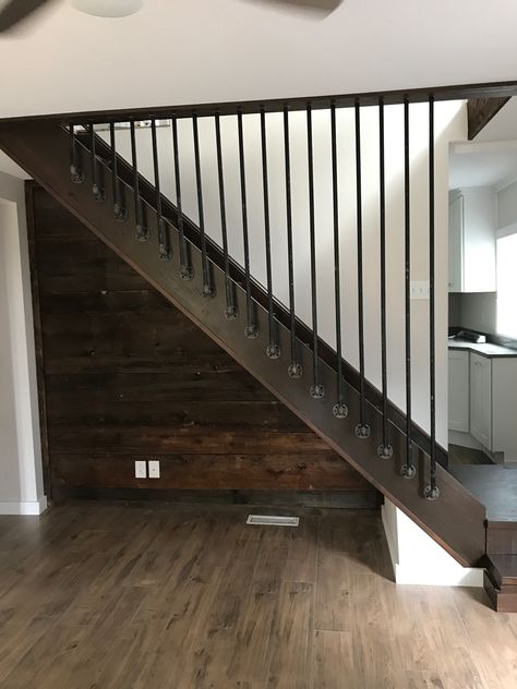 We used metal pipe to create these removable spindles.  Just unscrew and take off for easy access to getting furniture up the steps.  This is a great option for weird angles and we didn’t want to close this in with drywall. Basement Steps Railing Ideas, Basement Stairwell Railing Ideas, Removable Banister Ideas, Basement Step Railing Ideas, Basement Handrail Ideas, Diy Loft Railing Cheap, Basement Railing Ideas, Removable Stair Railing Ideas, Basement Stair Railing Ideas