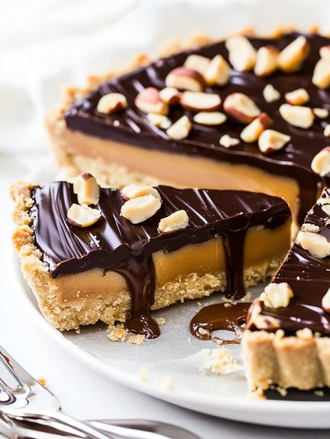 Snickers Caramel Tart, A Sweet & Salty Slice of Heaven!

 Ingredients
For Crust:
1 3/4 cups (220g) salted roasted peanuts, divided
1 cup (125g) all-purpose flour
2 tbsp (25g) light brown sugar
1/4 tsp salt
1/2 cup (113g) cold unsalted butter, cubed
3 tbsp (45ml) ice water
For the Filling:
1 cup salted caramel sauce
1 cup salted roasted peanuts, chopped
For the Topping:
6 oz milk or semi-sweet chocolate, chopped
2 tbsp creamy peanut butter
Optional Garnishes:
Chopped Snickers bar
Crushed peanuts Snickers Dessert, Triple Chocolate Mousse Cake, Story Names, Chocolate Covered Strawberry Cake, Caramel Pie, Chocolate Poke Cake, Caramel Tart, Snickers Bar, Cream Cheese Muffins