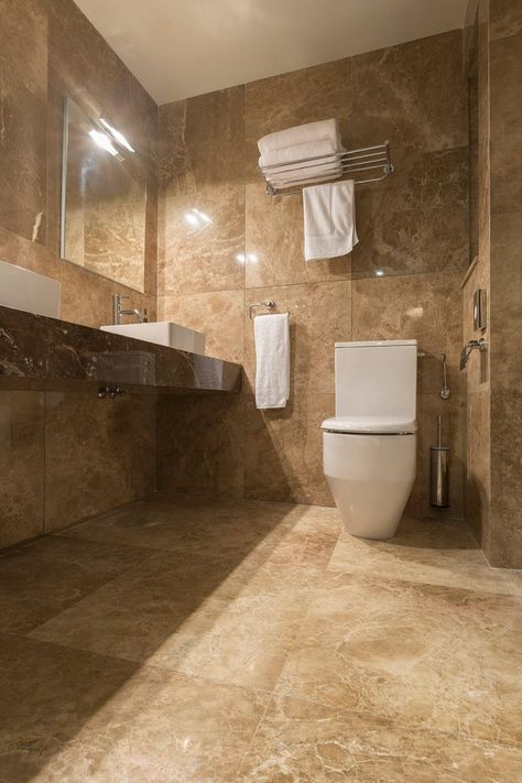 The bathrooms feature marble such as Giallo Antico and Emperador Dark vanities. #marble #gialloantico #emperadordarkvanities #halmannvella Dark Beige Bathroom, Brown Marble Bathroom, Beige And Brown Bathroom, Brown And Beige Bathroom, Beige Marble Bathroom, Brown Tile Bathroom, Cosy Bathroom, Master Baths, Brown Tile