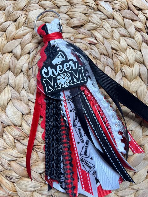 Please add note on personalization what ribbon colors you might want  (Also ribbons may vary ) Add some personalized flair to your Bogg Bag with this custom Cheer Mom Ribbon Tassel! 🌟 Whether you're cheering from the sidelines or traveling to the next big competition, this stylish accessory is the perfect way to show off your team spirit. 🎀 Key Features: *Customizable with your choice of ribbon colors to match your cheer team or favorite colors! *Made with high-quality, durable ribbons and tassels to withstand daily use. *Easily clips onto any Bogg Bag, purse, or backpack for a pop of color and personality. *Perfect gift for Cheer Moms, Cheerleaders, or anyone who loves a stylish bag charm. 🛍 Why You'll Love It: This ribbon tassel isn't just a cute addition to your bag--it's a symbol of How To Make A Bogg Bag Tassel, Cheer Sister Gift Ideas, Bogg Bag Ribbon Tassel Diy, Cheer Gifts Diy, Diy Bag Tags, Bogg Bag Tassel, Cheer Sister Gifts, Bogg Bag Charms, Cheer Mom Gifts