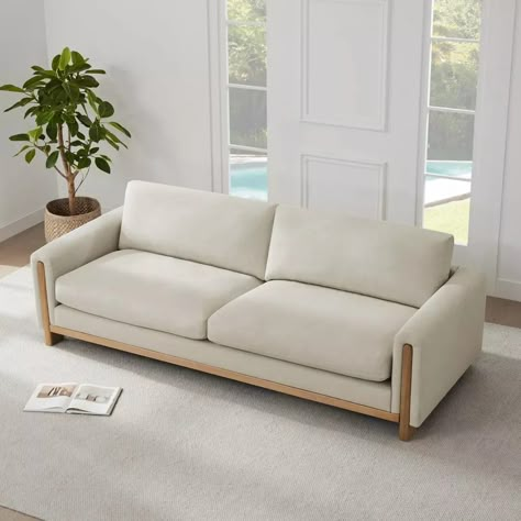 The original wood's warm, natural hue traces a harmonious H-shape, masterfully outlining the sofa's silhouette. Its clean lines, astutely juxtaposed with gentle curves, skillfully defy rigidity, offering a visual harmony that is nothing short of captivating. Fixed solid Ash wood base features a natural finish. Pillowy-soft cushions are padded with a soft blend of fiber and sterilized feathers. All cushions are loose and reversible with zip-off covers. Cushions can be easily fluffed to maintai... Sofa With Wood, Latest Sofa Designs, House Interior Design Styles, Modern Leather Sofa, Furniture Details Design, Simple Sofa, Wooden Sofa Set, Aesthetic Living Room, Interior Minimalista