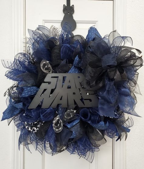 Star Wars wreath made with navy blue Deco mesh, black Deco mesh and charcoal mesh from Jo-Ann Fabric. Navy blue ribbons, black ribbons. Simple Star Wars Mesh wreath. Wreath for men. Wreath for Star Wars fan. Handmade by Bee. 2023. Star Wars Wreath, Star Wars Christmas Decorations, Star Wars Decor, Fabric Navy, Star Wars Christmas, Ornament Ideas, Wreaths Diy, Mesh Wreath, Black Ribbon