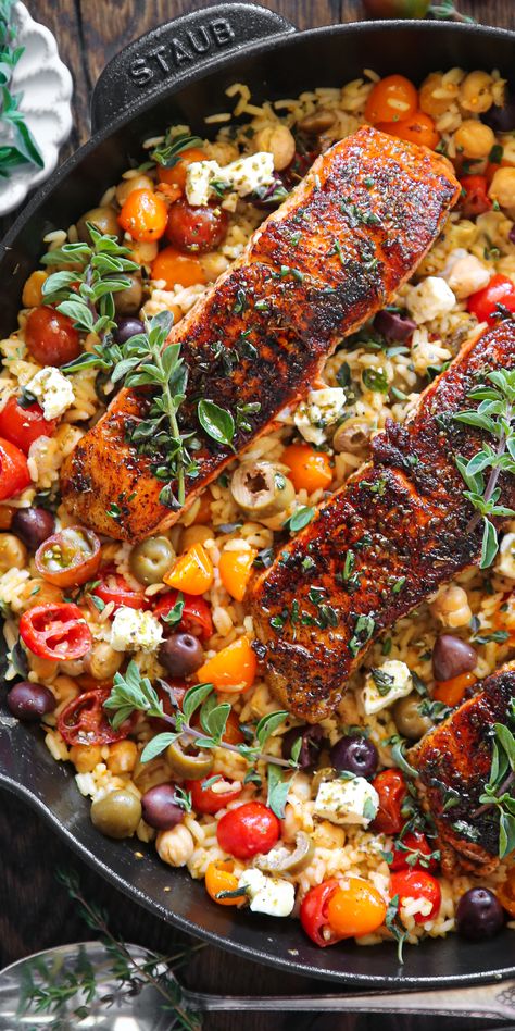 Mediterranean Salmon & Rice with Chickpeas, Cherry Tomatoes, Olives, Lemon, Oregano, and Feta Cheese - in a cast iron skillet. Mediterranean Recipes Healthy, Mediterranean Salmon, Mediterranean Diet Recipes Dinners, Fish Dinner Recipes, Mediterranean Diet Meal Plan, Easy Mediterranean Diet Recipes, Salmon And Rice, Salmon Dinner, Salmon Dishes