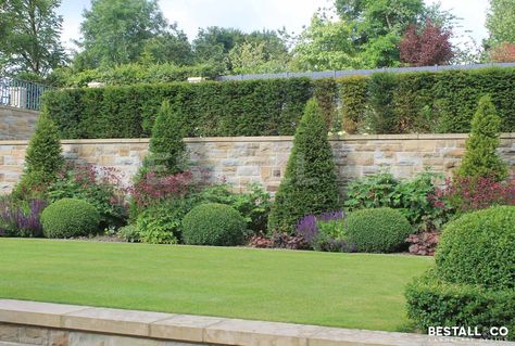 Italian terraced garden - This large formal scheme displays symmetry & balance. A twin York Sandstone spiral staircase rises from the first terrace, elevating visitors to the second terrace garden. A selection of formally planted level areas create smaller, more intimate rooms, where perfect topiary and beautiful stone pots are placed to make the most of each vista. With resting places scattered around this Yorkshire garden, you have many places to sit and relax. Tiered Landscaping, Italian Garden Ideas, Yorkshire Garden, Steep Gardens, Terraced Garden, Sloped Backyard Landscaping, Backyard Seating Area, Sloped Backyard, Terrace Garden Design