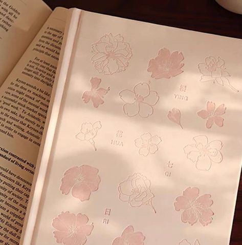 Introducing our Japanese Style Cherry Blossoms Notebook, the perfect companion for students and anyone seeking a beautifully designed and functional notebook. This notebook is not only a practical tool for organizing your thoughts, but also a delightful student gift or a personal diary, planner, or journal for your everyday needs. With a size of 21 cm (high) x 14.5 cm (width), this notebook offers ample writing space while remaining portable and easy to carry. Its 192 pages, or 96 leaves, provid Korean Notebook Cover, Japanese Notebook, School Bag Essentials, Student Notebooks, Spring Shower, Writing Notebook, Small Notebook, Writing Space, Cute Notebooks