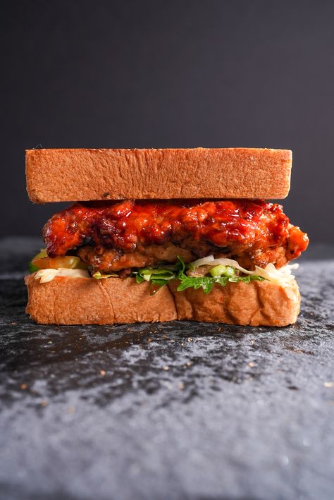 Korean Fried Chicken Sandwich Korean Chicken Sandwich Recipes, Korean Fried Chicken Sandwich, Barbeque Sandwiches, Kimchi Slaw, Shiso Leaves, Ultimate Sandwich, Sticky Sauce, Beer Chicken, Buttermilk Fried Chicken