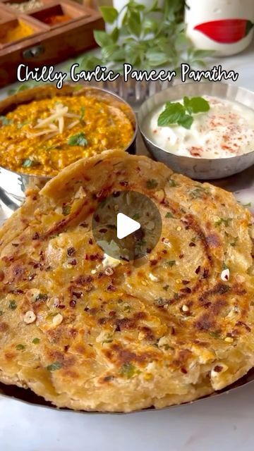 Foodklick on Instagram: "✨ Chilly Garlic Paneer Paratha ✨

Chilly Garlic Paneer Paratha is a flavorful, stuffed Indian flatbread made with a spicy paneer filling, enhanced with garlic and chili. It’s a fusion of traditional paratha with a zesty twist, perfect for breakfast, lunch, or dinner. The combination of crumbled paneer, garlic, and chilies delivers a savory punch, while the paratha provides a soft, crisp exterior.

Ingredients:
For the dough:

2 cups whole wheat flour
1/2 teaspoon salt
Water (as needed to make a dough)
1 tablespoon oil or ghee
paneer (cottage cheese), grated 
4-5 garlic cloves, finely chopped
1/2 teaspoon red chili flakes
Salt, to taste
1 tablespoon fresh coriander leaves, chopped (optional)
1 tablespoon oil or ghee (for cooking the parathas)
.
.
.
#chilli #garlic # Chilli Garlic Paratha, Paneer Paratha, Indian Flatbread, How To Make Paneer, Salt Flakes, Red Chili Flakes, Coriander Leaves, Chili Flakes, Red Chili