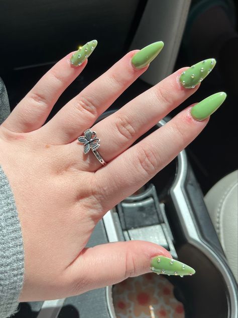 sage green sparkly rhinestone acrylic nails Holiday Nails With Rhinestones, Rhinestone Green Nails, Dark Green Nails With Rhinestones, Green Nails With Jewels, Green Nails With Diamonds, Green Rhinestone Nails, Green Nails With Rhinestones, Peridot Nails, Green Acrylic Nails