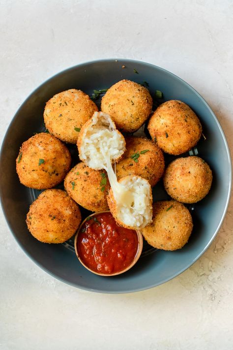 These Arancini Rice Balls are golden and crispy on the outside and creamy and cheesy on the inside! They are made with U.S-grown basmati rice, (as opposed to the traditional risotto), are breaded, and then deep fried to golden perfection. #arancini #riceballs #italian #ricerecipes #appetizers #arborio #risotto Traditional Food Photography, Traditional Risotto, Arancini Rice Balls, Italian Rice Balls, Traditional Italian Food, Arancini Recipe, Italian Rice, Resep Smoothie, Website Menu