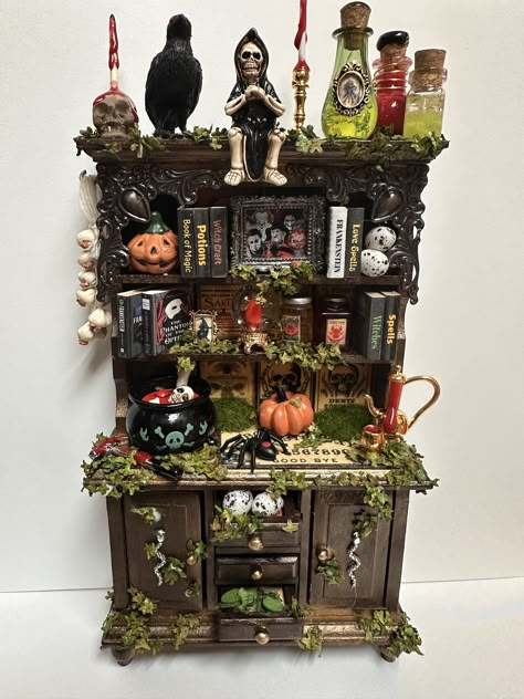 Miniature witches hutch for your haunted dollhouse or spooky diorama.   It is a handmade item in 1:12 scale. All items are included and attached to a wooden hutch. It comes complete with everything a tiny witch needs to make her house a spooky home.  appx 8 X 4.5 in.  *This is a handmade item so look and accessories may vary slightly  * Not intended for children * Choking hazard Witch Diorama, Spooky Diorama, Haunted Dollhouse Diy Ideas, Witch Furniture, Spooky Dollhouse, Witch Dollhouse, Monster High Dollhouse, Witch Decorations, Woodwork Furniture