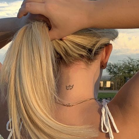 Small angel dainty tattoo at back of neck Harry Styles Tattoo Minimalist, Dainty Tattoos Harry Styles, Harry Styles Tattoo Aesthetic, Minimalistic Harry Styles Tattoo, Dainty Back Of Neck Tattoos For Women, Dainty Tattoos Back, Small Tattoos Harry Styles, Harry Styles Coded Tattoos, Wings Small Tattoo