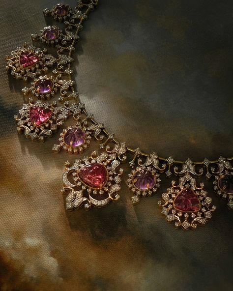 Dressed in a harmonious duet of art and grace, our Tapsee Necklace brings together the brilliance of diamonds and the vibrance of carved gemstones. Handcrafted in gold, the necklace is dressed in intricately designed graduating units set with carved tourmalines and amethysts, evenly spaced along its length. Halos of brilliant-cut diamonds surrounding the carved gems bring out their color even more. You may pair the necklace with our Tapsee Earrings and Tapsee Ring to create a complete look. Carved Gemstones, Amethyst Necklace, Brilliant Cut Diamond, The Necklace, Tourmaline, Gold Diamond, Halo, Amethyst, Gems