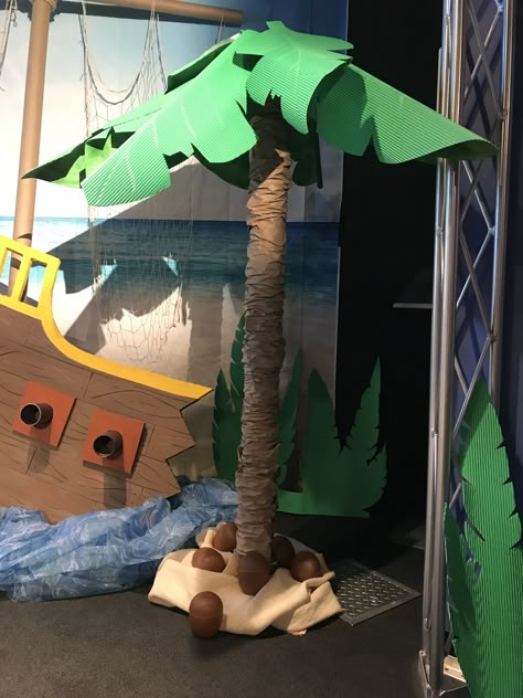 2018 Shipwrecked VBS stage decorations - my diy palm tree from a carpet tube, an umbrella and corobuff paper. Shipwreck Decor, Jumanji Party, Pirate Vbs, Pirate Snacks, Diy Palm Tree, Shipwreck Vbs, Vbs Shipwrecked, Shipwrecked Vbs, Gilligans Island