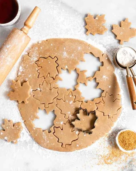 maple sugar cookie rolled out dough with cut out maple leaf cookies Maple Sugar Cookies, Maple Leaf Cookies, Thanksgiving Servings, Milk Chocolate Chip Cookies, Yummy Sugar Cookies, Caramel Buttercream, Leaf Cookies, Maple Sugar, Thanksgiving Cookies