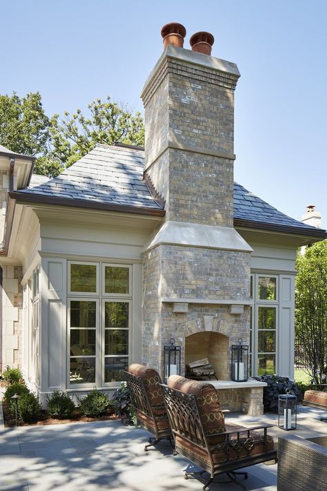 Set between floor-to-ceiling windows, this neutral brick fireplace adds elegance to a welcoming outdoor area from Reynolds Architecture, Design & Construction. #outdoorfireplace #patio #outdoorlounge Transitional Fireplace, Design Fireplace, Outdoor Fireplace Designs, Fire Design, Backyard Fireplace, Outside Living, Transitional House, Fireplace Ideas, Floor To Ceiling Windows