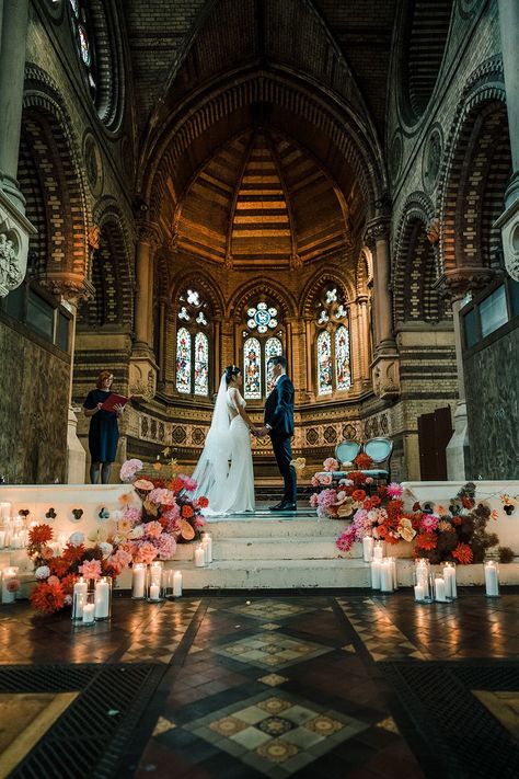 Colourful cascading florals line stairway during church wedding ceremony at St Stephen's Hampstead Colourful Aisle Flowers, Church Ceremony Wedding, Candle Wedding Aisle, Minimalist Church Wedding Decor, Colorful Ceremony Flowers, Wedding Church Aisle Decorations, Church Aisle Decor, Church Aisle Wedding Decor, Church Wedding Decorations Alter