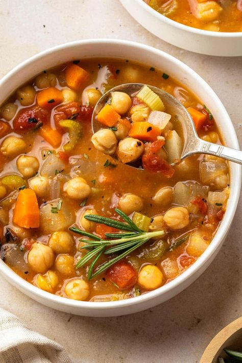 This hearty garbanzo bean soup is filled with flavorful vegetables and garbanzo beans - also known as chickpeas - simmered with savory herbs to create a filling and healthy soup that’s perfect for colder weather. Garbanzo Bean Stew, Garbanzo Soup Recipes, Cuban Garbanzo Bean Soup, Garbanzo Bean Curry, Garbanzo Bean Soup, Garbanzo Bean Recipe, Recipes With Garbanzo Beans, Spanish Bean Soup Recipe, Heart Healthy Soup