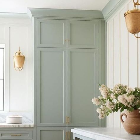 Tamra Lea #Itsahouselovestory on Instagram: "Laundry room design. I love the softness of the look; the creamy white on the wood board and batten with gorgeous shade of soft green/gray paint on the cabinets. The long table in blue-gray and marble contertops, perfect rustic  laundry baskets, multiple but simple verticle windows and the lighting really add beauty and charm to the space.   By @windthekey   •  #itsahouselovestory #windthekey #homedesign #designideas #laundryroom #laundryroommakeover #laundryroomdecor #laundryroomdesign #softpaint #laundryroominspo #laundryroomgoals #interiors #decor #interiordesign #becauseiloveit #loveit #woodfloors" Sage Cabinets Laundry Room, Colored Laundry Room Cabinets, Two Tone Laundry Room Cabinets, Laundry Room Ideas Green, Light Green Laundry Room, Painted Laundry Room Cabinets, Green Laundry Room Cabinets, Sage Green Laundry Room, Green Laundry Room