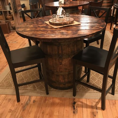 This is my newest whiskey barrel table. I used an actual Jim Beam barrel and stained it. I used a wire reel spool top for the top. I sanded it and torched it before I stained it. My wife picked out the perfect chairs for this beautiful table. It’s in our store, Lynthia Designs. Whiskey Barrel Table Top Diy, Wine Barrel Dining Table, Whiskey Barrel Dining Table, Whiskey Barrel Table Ideas, Barrel Tables Ideas, Whiskey Barrel Tables, Whiskey Barrel Bar Table, Diy Barrel Table, Wine Barrel Table Diy