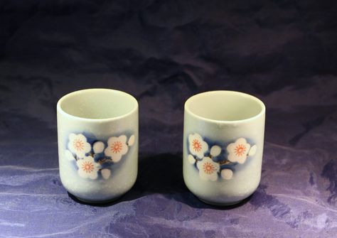 This is a set of 2 traditional Japanese teacups. They are ceramic and hand painted with stylized flowers. The cups are a speckled light blue with hints of darker blue behind the white flowers which have orange centers. Traditional Japanese, Conversation Piece, Japanese Traditional, White Flowers, The White, Barware, Etsy Accessories, Kitchen Dining, Light Blue