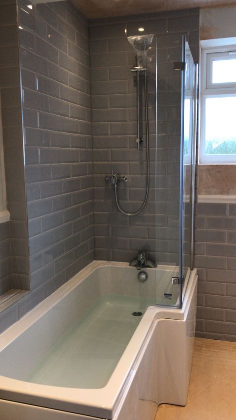 L shaped bath with screen Grey metro subway tiles L Bathroom Layout, L Shaped Bathtub, Bath Shower Ideas, L Shape Bathroom, L Shape Bathroom Layout, L Shaped Bath Shower Combo, Bathroom L Shaped Bath, Bathroom Ideas L Shape Bath, Small Bathroom L Shaped Bath